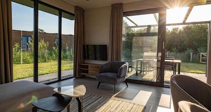 This vacation home, with a private sauna and hot tub, has a cozy homey living room with an open kitchen, 2 bedrooms, and generous outdoor space.