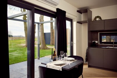 The luxurious two-person hotel studio with a beautiful patio, high windows and sliding doors offers a surprising amount of privacy, space and comfort.