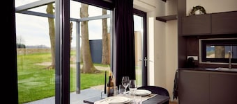 The luxurious two-person hotel studio with a beautiful patio, high windows and sliding doors offers a surprising amount of privacy, space and comfort.