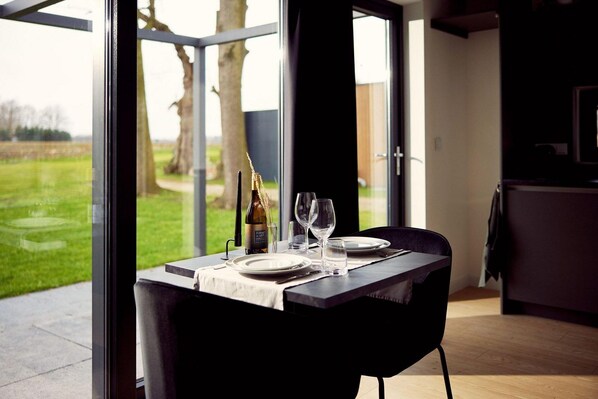 Dining - The luxurious two-person hotel studio with a beautiful patio, high windows and sliding doors offers a surprising amount of privacy, space and comfort. (Kotten)