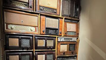 A wall of vintage radios in various sizes and designs, arranged in a grid pattern.