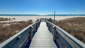 A wooden boardwalk leading to a beach with clear skies. - Tidewater 907-Family friendly complex to enjoy the Beach! (Orange Beach)