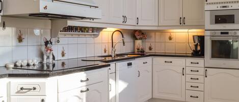 Fridge, stovetop, dishwasher, coffee/tea maker