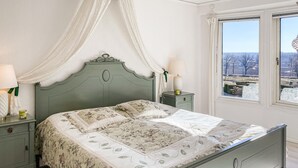 A bedroom with a bed, nightstands, a window with a view, and a canopy. - Lovely home in Söderköping with sauna (Söderköping)