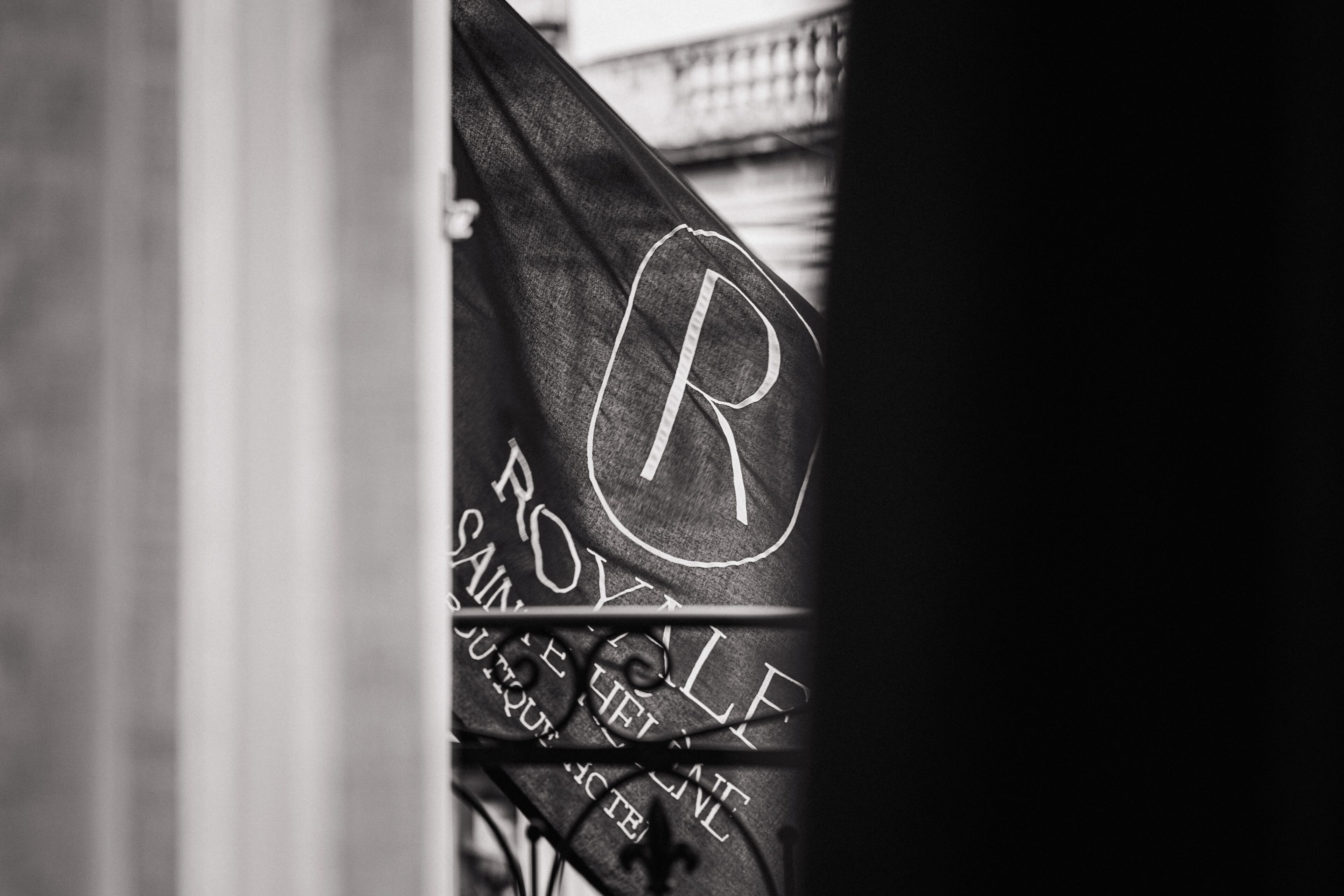 A black and white photo of a sign with the letter 'R' and the words 'ROYAL' and 'SAINT-CHAPEL' visible.