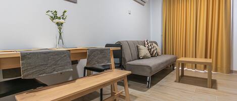 En moderne stue med en sofa, et spisebord og stole.