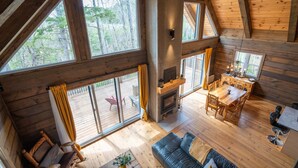 A spacious cabin with a large dining area, a cozy living room, and a fireplace.