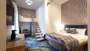 A modern bedroom with a bunk bed, a desk, and a chair.