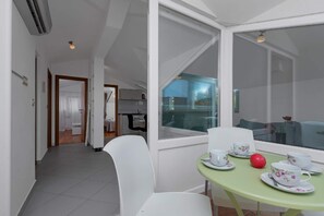 Enjoy a meal for two in the dining area with a view of the outdoors.