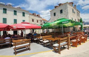 Situated in a historic town, this outdoor seating area offers a casual dining experience amidst traditional architecture.