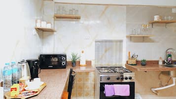 Family Apartment, 3 Bedrooms | Private kitchen | Full-size fridge, microwave, oven, stovetop