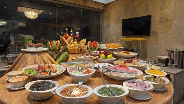 A buffet with various food items and condiments. - Watercress Hotels and Signature (Lagos)