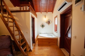 A wooden staircase leading to a room with a wooden bathtub, a wooden chair, and a wooden door. - Ağva Tias Shelale Otel (Sile)