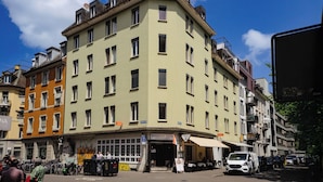 A multi-story building with a restaurant named 'Restaurant Vulkan' at the ground level.