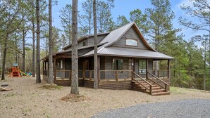 A cabin with a porch, wooden deck, and a small staircase leading to the entrance. - 3 bedroom with game room! (Broken Bow)