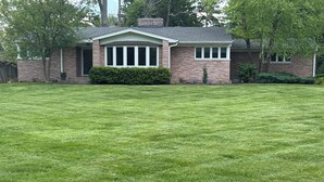 A house with a well-maintained lawn, brick exterior, and a front porch. - Large House Rental in Historic Area (Indianapolis)