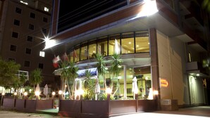 A hotel with a curved facade, large windows, and outdoor seating with umbrellas. - SEFA 2 BUTİK HOTEL (Corlu)