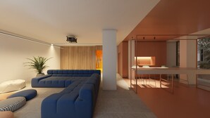 Un salon moderne avec un canapé d’angle, une petite table et une plante en pot.