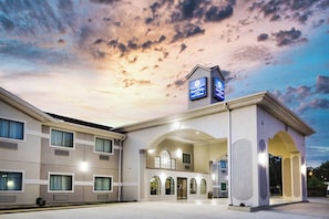 A hotel with a modern facade, multiple entry points, and a prominent sign indicating it is a Best Western property. - Surestay Studio by Best Western Conroe Downtown (Conroe)