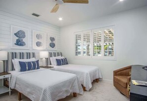 A bedroom with two beds, a window with blinds, and artwork on the wall. - Triple Crown Villa- Boaters paradise with Pool (Key West)
