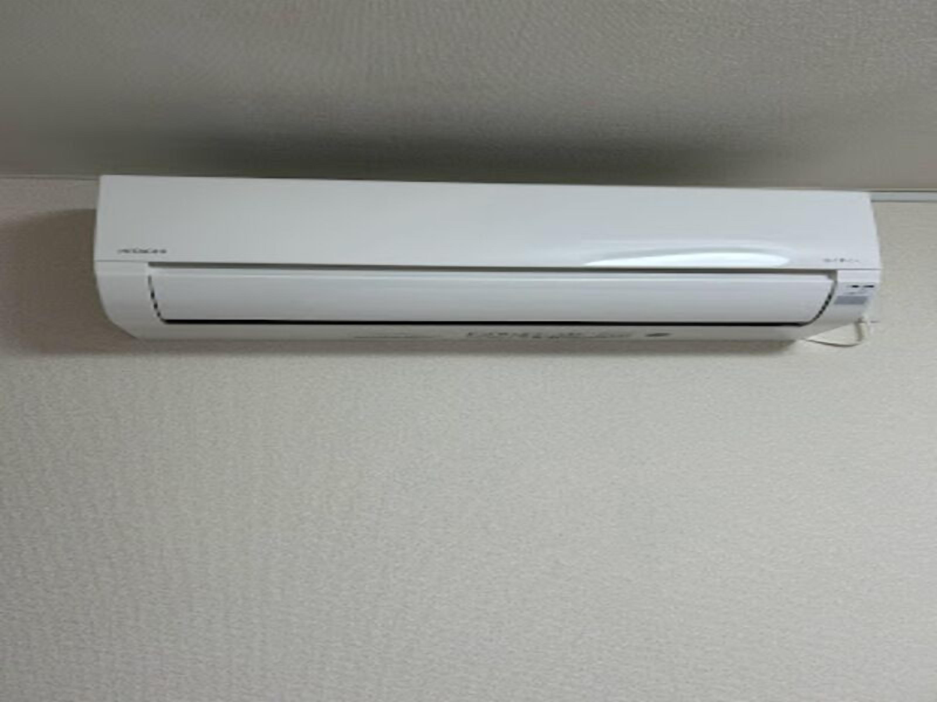 A white air conditioning unit mounted on a wall.