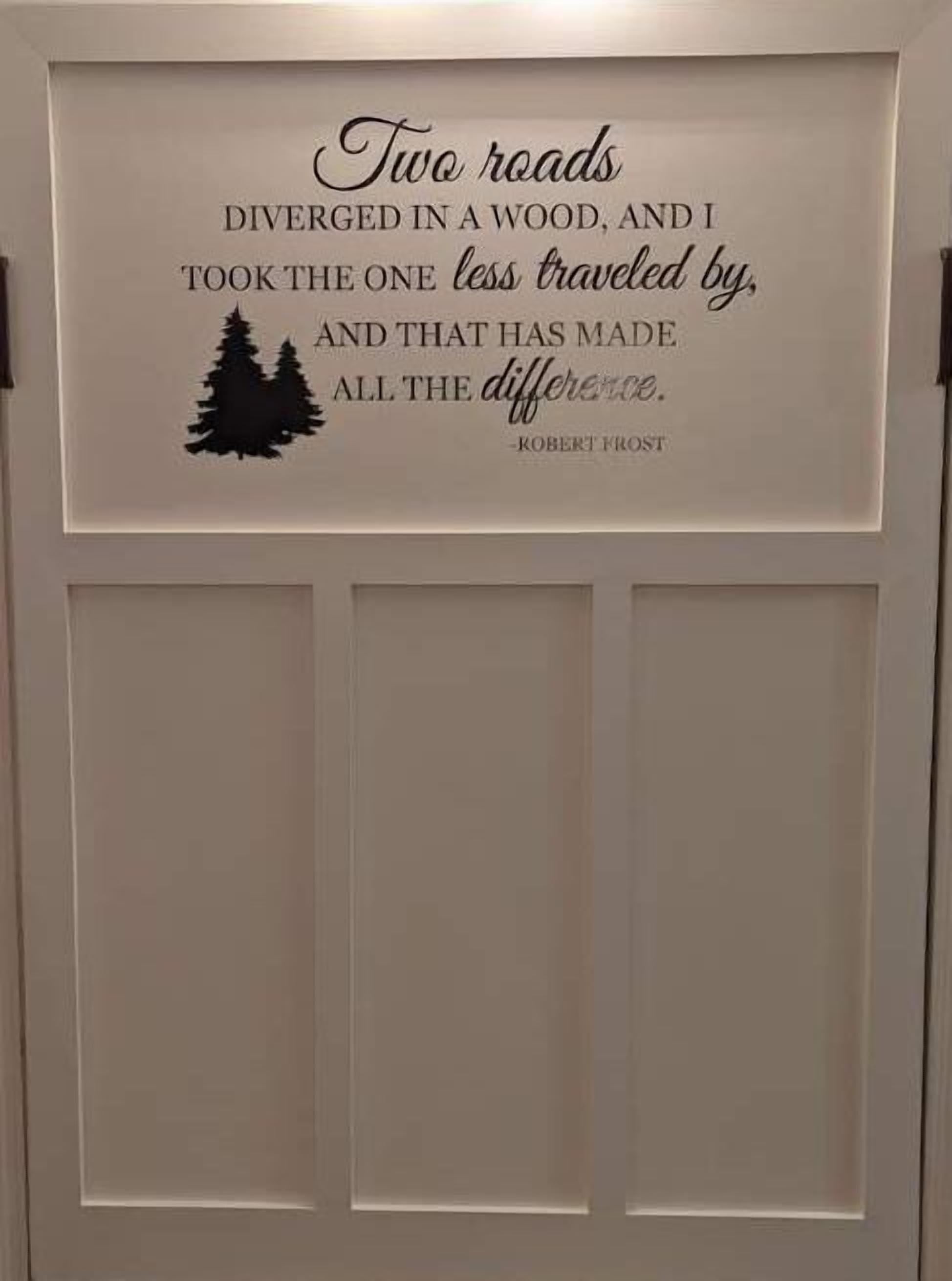 A door with a quote by Robert Frost and a silhouette of trees.
