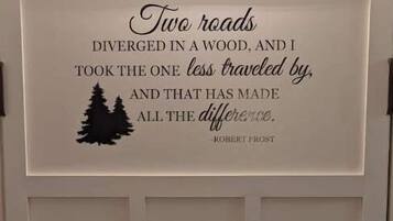A door with a quote by Robert Frost and a silhouette of trees.