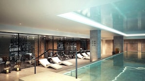 A modern indoor pool area with lounge chairs and a glass wall. - Luxury 2 Bedroom Apartment Near Central London (London)