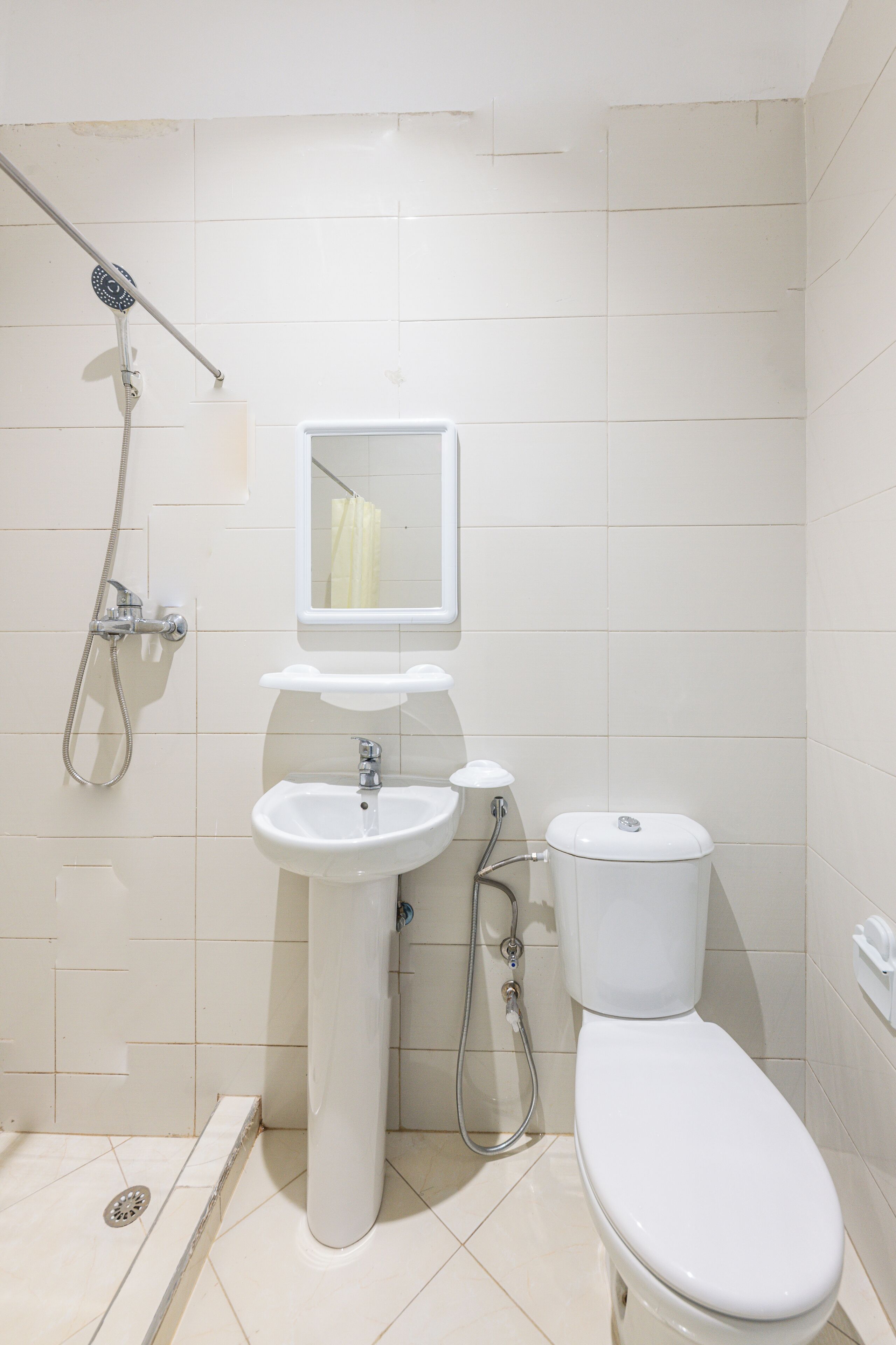 A bathroom with a sink, toilet, and shower.
