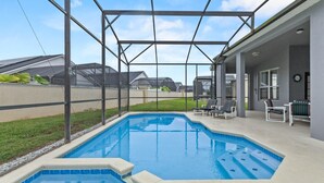 A swimming pool with a covered area, surrounded by a fence, and a patio with chairs. - 3Br 2Ba Private Pool Villa Just Steps Away From (Kissimmee)
