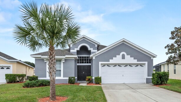 A single-story house with a grey facade, a black front door, and a white garage door. - 3Br 2Ba Private Pool Villa Just Steps Away From (Kissimmee)