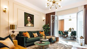 A living room with a sofa, coffee table, and a painting on the wall. - Qult·co - The Renaissance Affair (București)