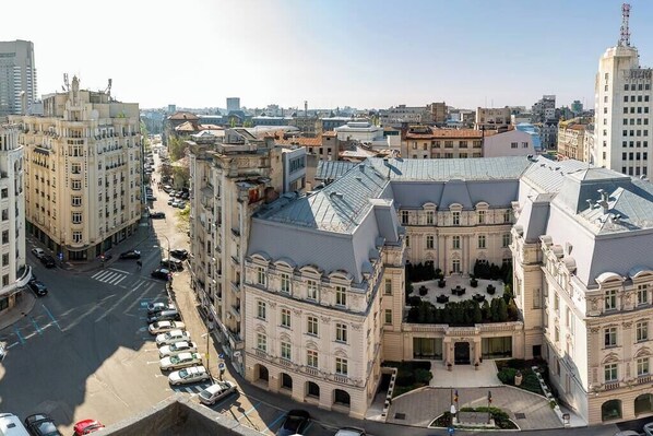 A large, historic building with a central courtyard, surrounded by other buildings.