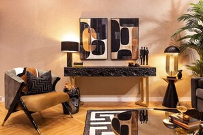 A modern living room with a sofa, a coffee table, and a decorative lamp.