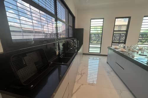 Luxury Villa | Private kitchen | Full-size fridge, microwave, stovetop, electric kettle