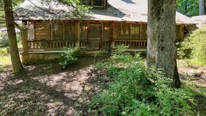 A rustic cabin with a wooden exterior, a porch, and a chimney. - Rustic Historical Cabin near Wineries & Gold Mines (Dahlonega)