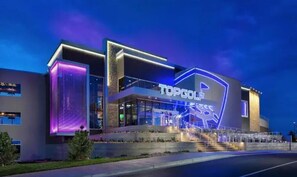 TOPGOLF offers a sleek, contemporary building with a flat roof and illuminated entrance.