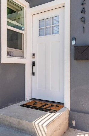 Welcome to 2401, where a cozy entrance awaits with a door, window, and mailbox.