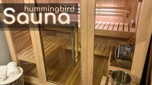 A sauna with wooden benches and a glass door. - Mountain Meadows Retreat - A Romantic Escape Overlooking the Ozark Mountains (Reeds Spring)