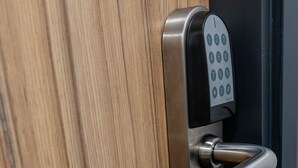 A modern door with a numeric keypad lock and a metallic handle. - Hotel No.9 (Londonderry)