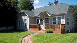 A two-story house with a front porch, a brick pathway leading to the entrance, and a well-maintained lawn. - Yakima Vacation Rentals- Spacious Bungalow
 (Yakima)