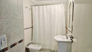 A small bathroom with a toilet, bidet, and sink. - Large Apartment Villa Urquiza (Buenos Aires)