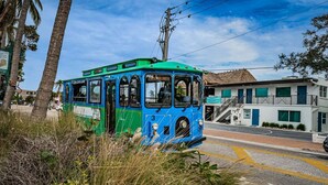 A blue and green tram on a street with a building labeled 'Lobby' in the background. - Villa 27 - Premium Plus (Siesta Key)
