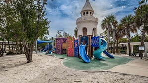 A playground with a castle-like structure, slides, and climbing areas.