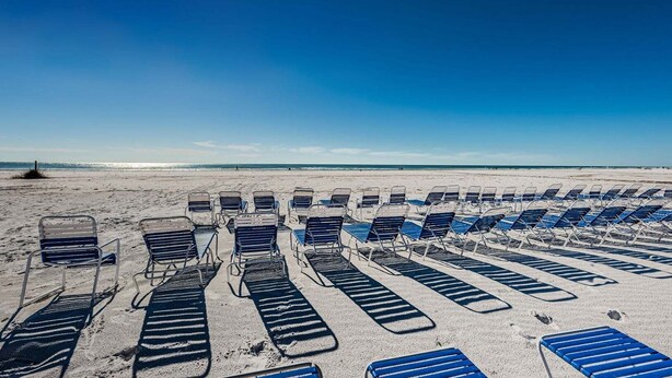 A beach with rows of sun loungers aligned parallel to the shoreline. - Villa 38 - Premium - Aloha Kai Vacation Villas (Siesta Key)