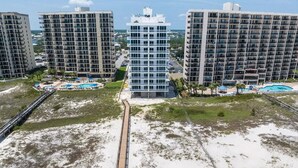 A high-rise hotel with multiple balconies, a central pool area, and a beach access walkway. - Unwind by the Beach in Orange Beach! 4 bed/3bath - Sleeps 8 - Oceanfront View (Orange Beach)