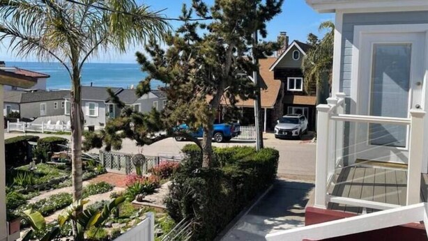 A residential street with houses, a clear sky, and a view of the ocean. - Fifth house from beach Avail June 14 - August18.  (Pismo Beach)