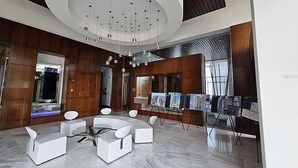 A modern lobby with a circular ceiling design, marble flooring, and contemporary furniture. - Atlantis Loft Studio by Stay Here PR (San Juan)