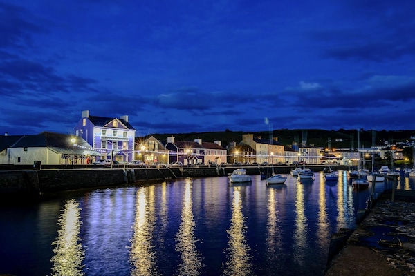 Aberaron Harbour at night with lights reflected in the water