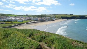 A coastal town with a sandy beach, a promenade, and buildings along the shore. - Seymour, Johnston - Two Bedroom Cottage, Sleeps 4 (Johnston)